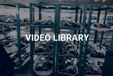 The words "Video Library" are across the image in white. There are shelves lining the photo. The shelves have various ATM parts on them, such as printers, cash cassettes, and more.